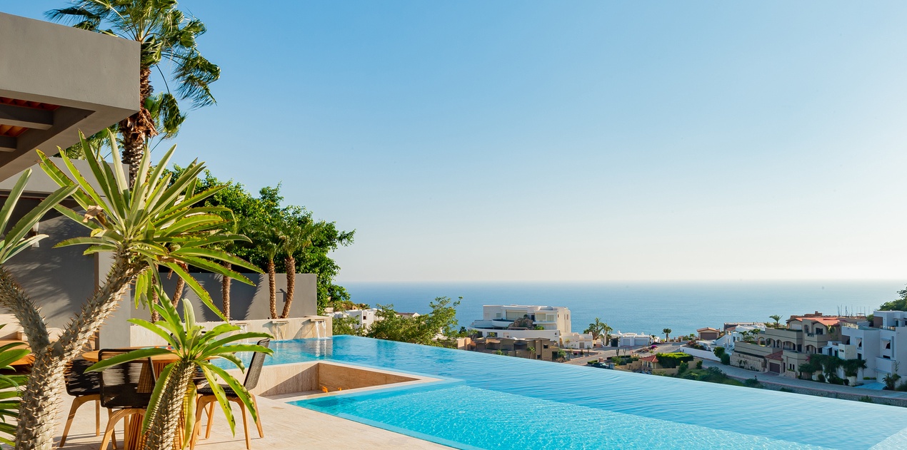 Sunny patio with infinity pool and ocean view