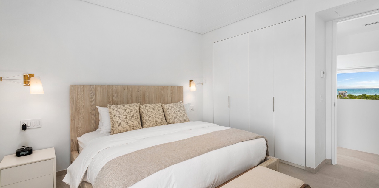 Rest peacefully in your bright bedroom with ocean glimpses through the window and ample wardrobe space for your vacation wardrobe.