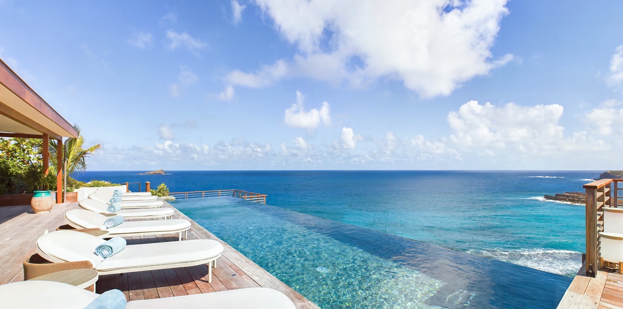 Stunning infinity pool deck with pristine ocean views and comfortable loungers for ultimate relaxation.