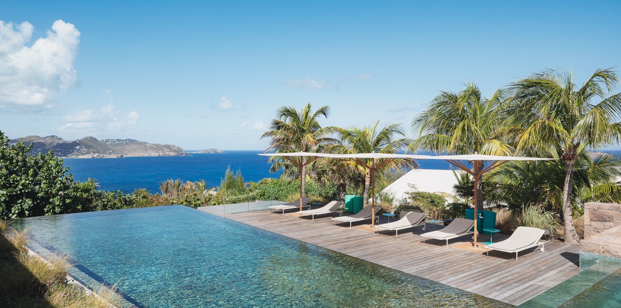 Stunning infinity pool with ocean views and tropical paradise surroundings creates the perfect Caribbean escape.
