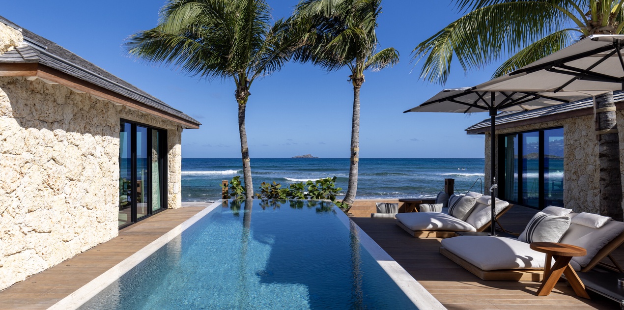 Wake up to your own slice of paradise with an infinity pool overlooking turquoise waters and swaying palms at your beachfront retreat.