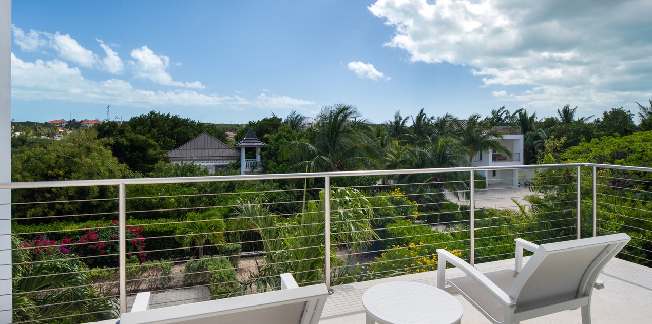 Unwind on your private terrace with panoramic views of lush tropical gardens and palm trees stretching to the horizon.