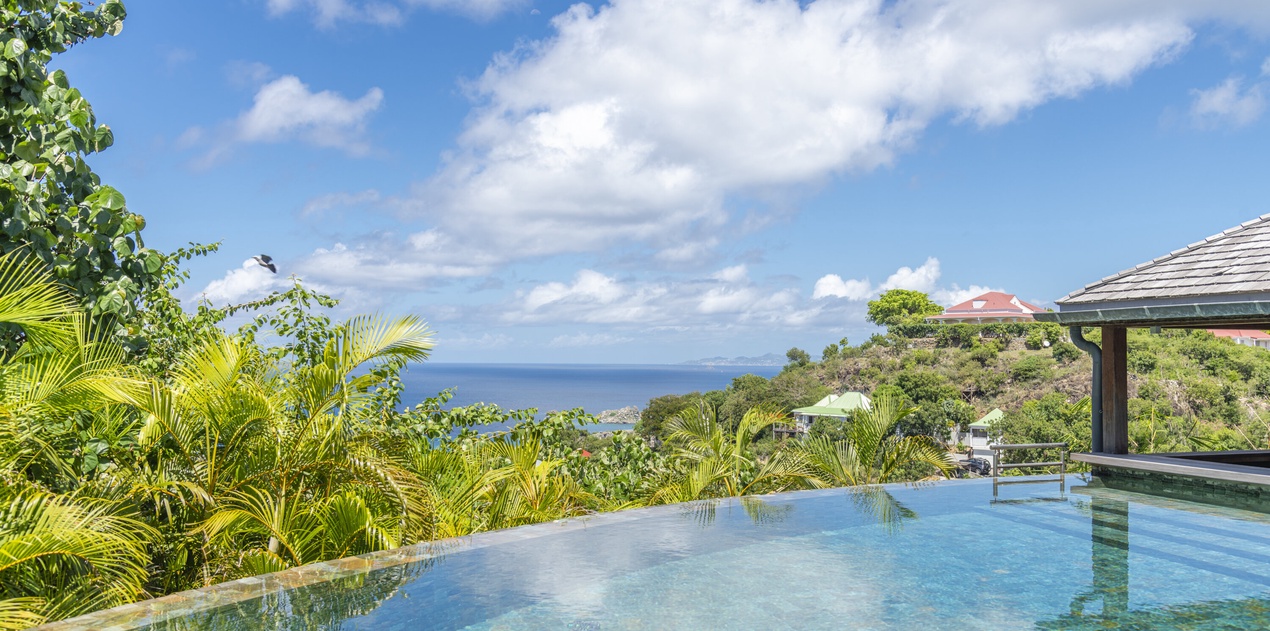 Swim in your private infinity pool as you gaze over lush tropical palms toward the sparkling Caribbean Sea stretching to the horizon.