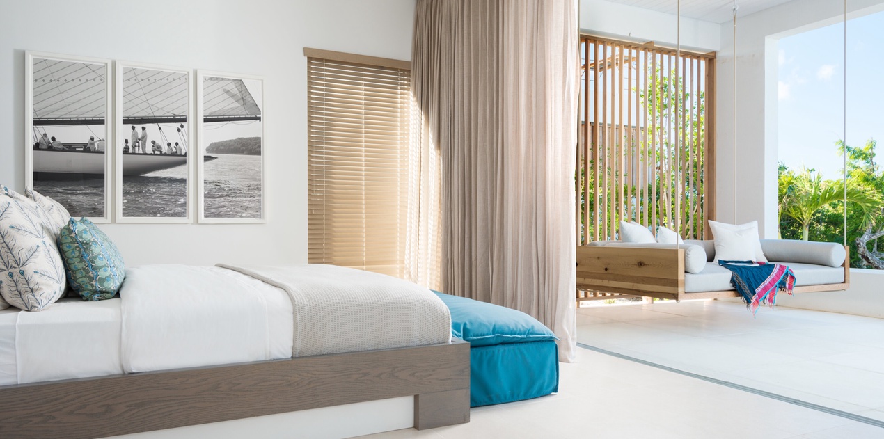 Wake up in your serene bedroom where soft ocean breezes flow through, complete with private balcony seating overlooking tropical gardens.