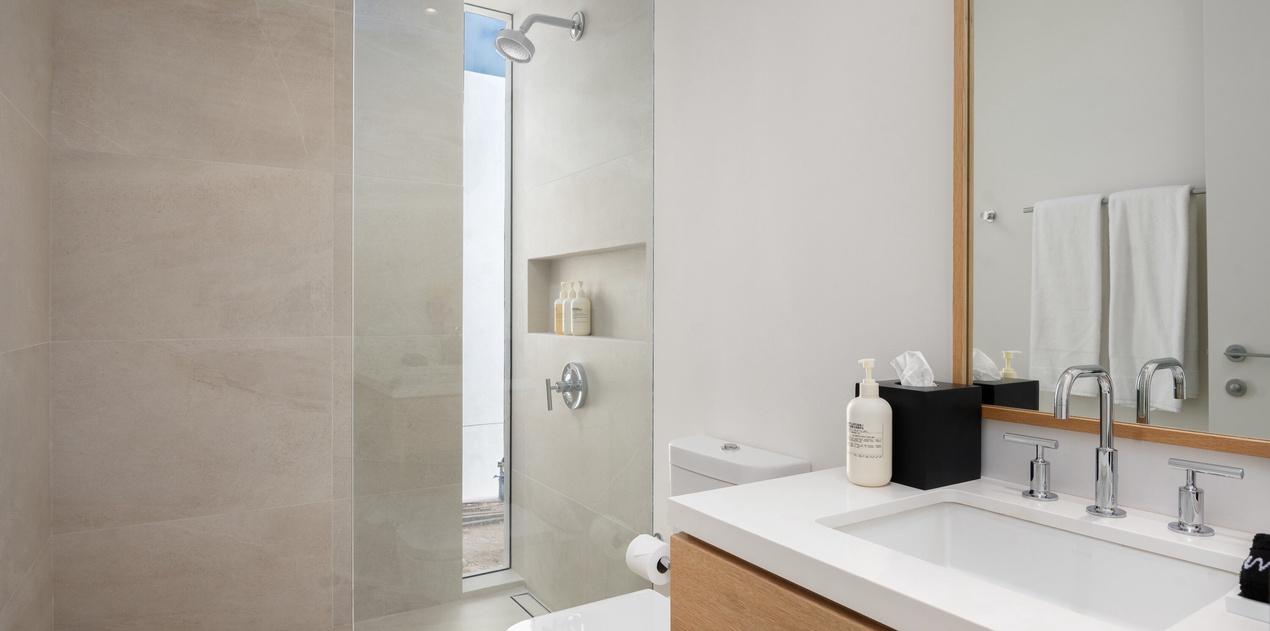 Step into your sleek spa-like bathroom with a spacious walk-in shower, elegant vanity, and premium amenities waiting for your arrival.