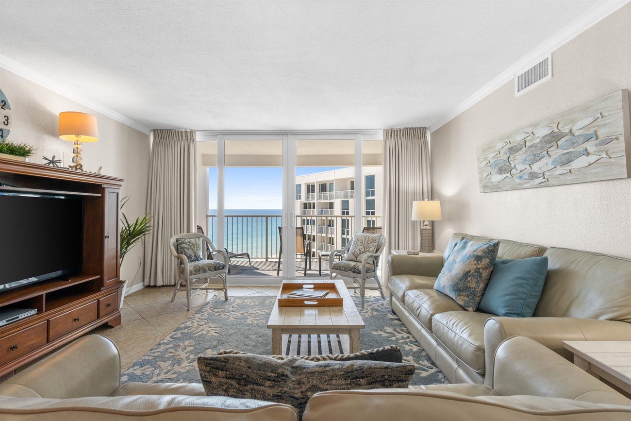 Sink into plush leather seating while ocean waves sparkle beyond your floor-to-ceiling windows, creating the perfect coastal retreat.