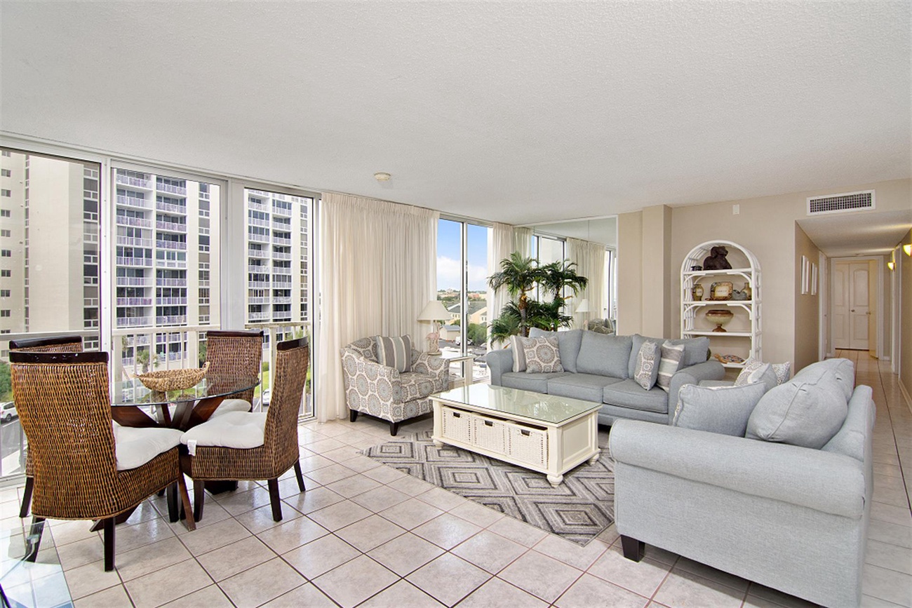 Your bright living space offers stunning city views through floor-to-ceiling windows, perfect for relaxing after exploring nearby attractions.