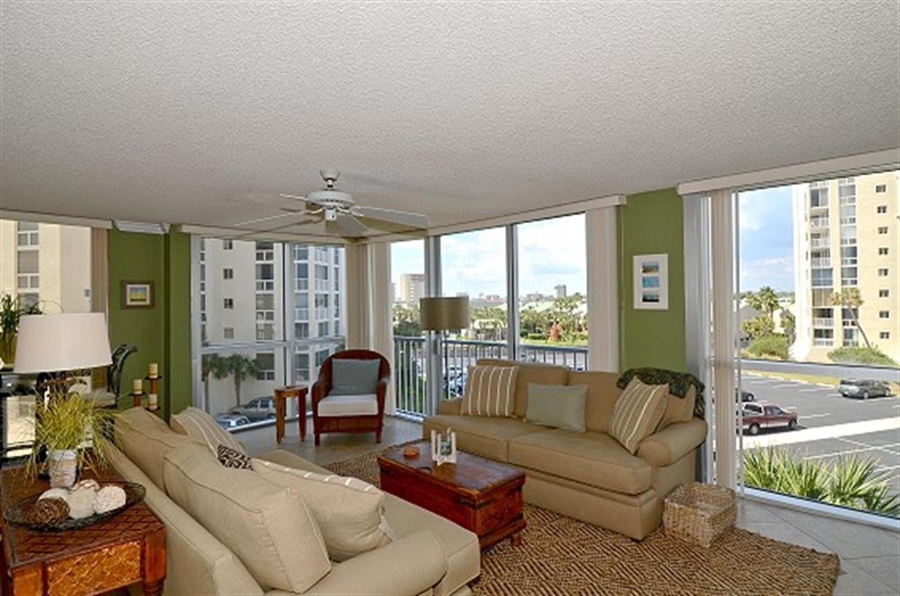 Unwind in your spacious living room with panoramic city views through floor-to-ceiling windows.