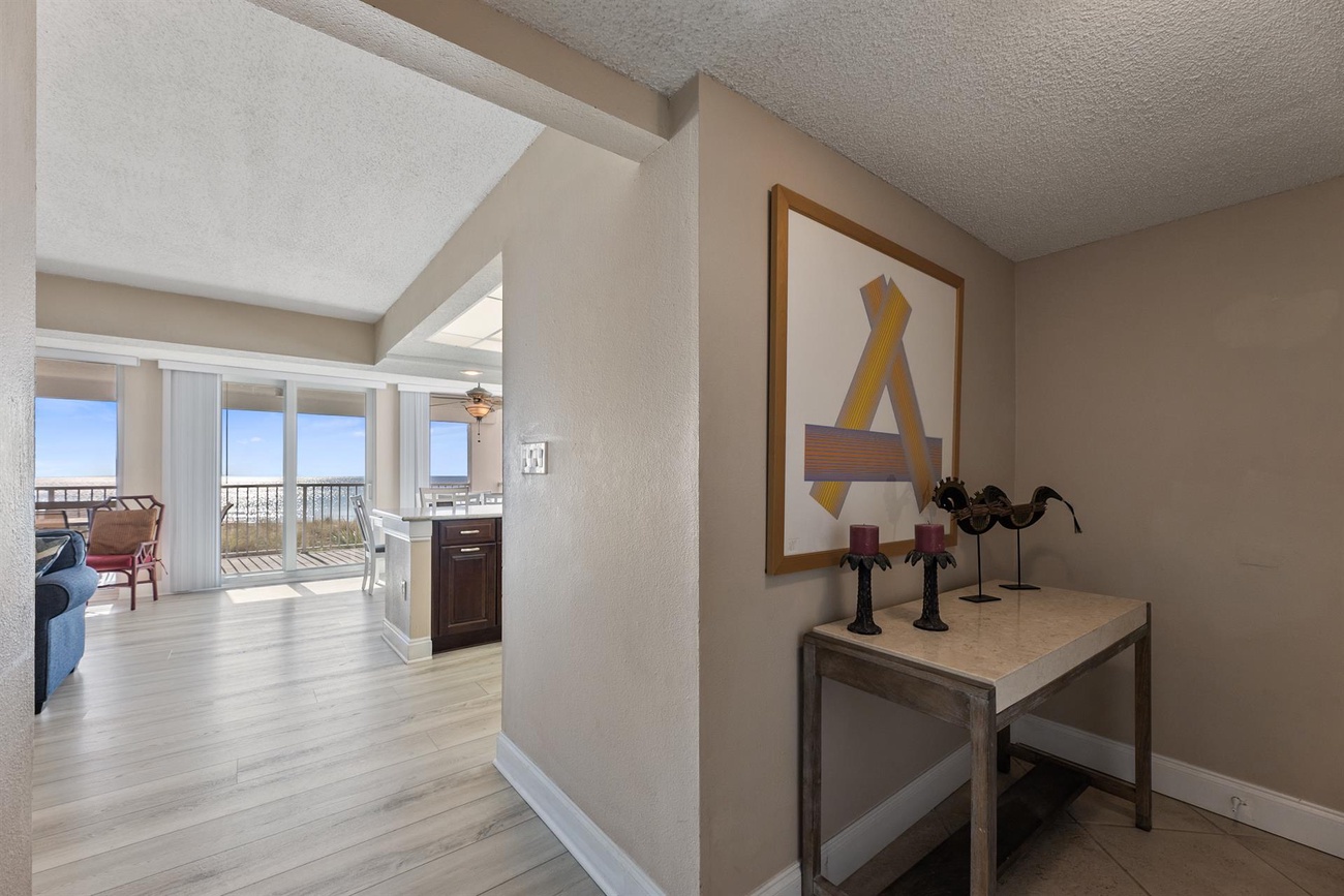 You'll love this stylish open-concept layout with modern artwork and glimpses of your private balcony beyond.