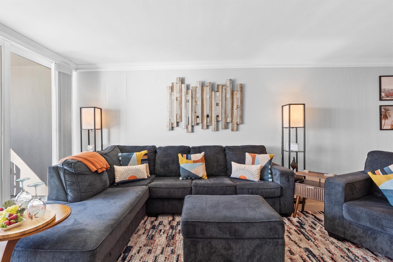 Sink into plush sectional seating with vibrant pillows, perfect for movie nights or morning coffee in your stylish retreat.
