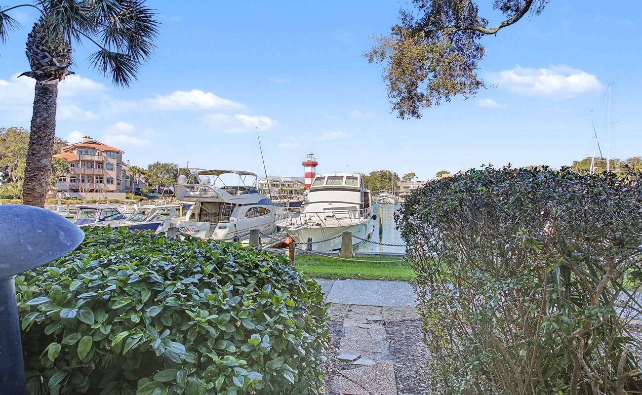 Scenic marina pathway with boats and palm trees in the charming coastal neighborhood surrounding the property.