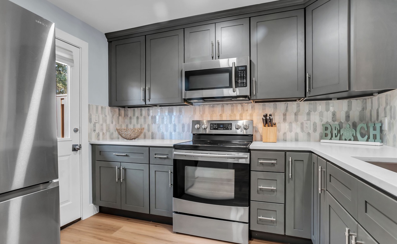 Your fully equipped kitchen features stainless steel appliances and ample cabinet space for preparing memorable meals during your stay.