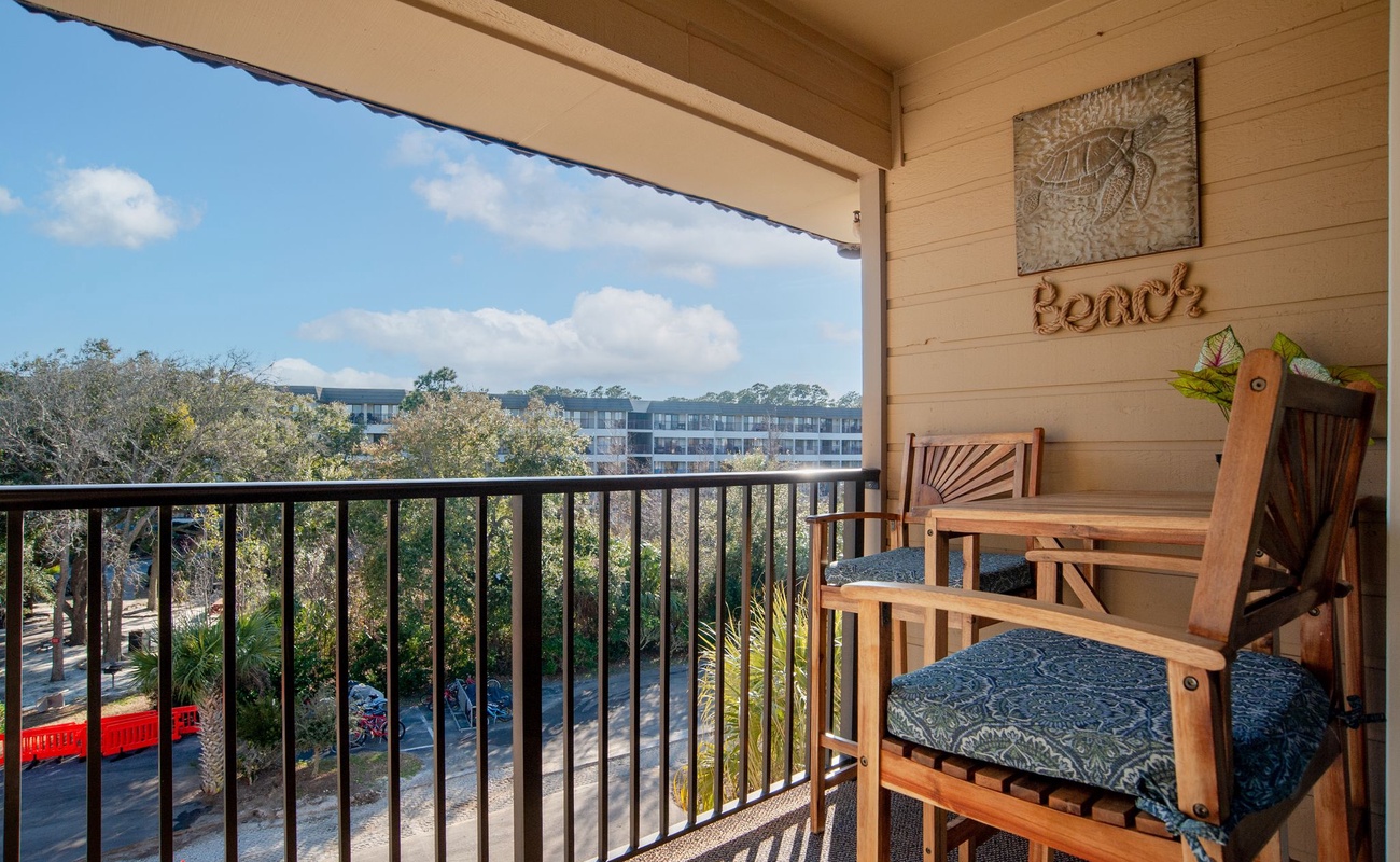 Unwind on your private balcony with comfortable seating and peaceful tree-lined views stretching across the neighborhood.