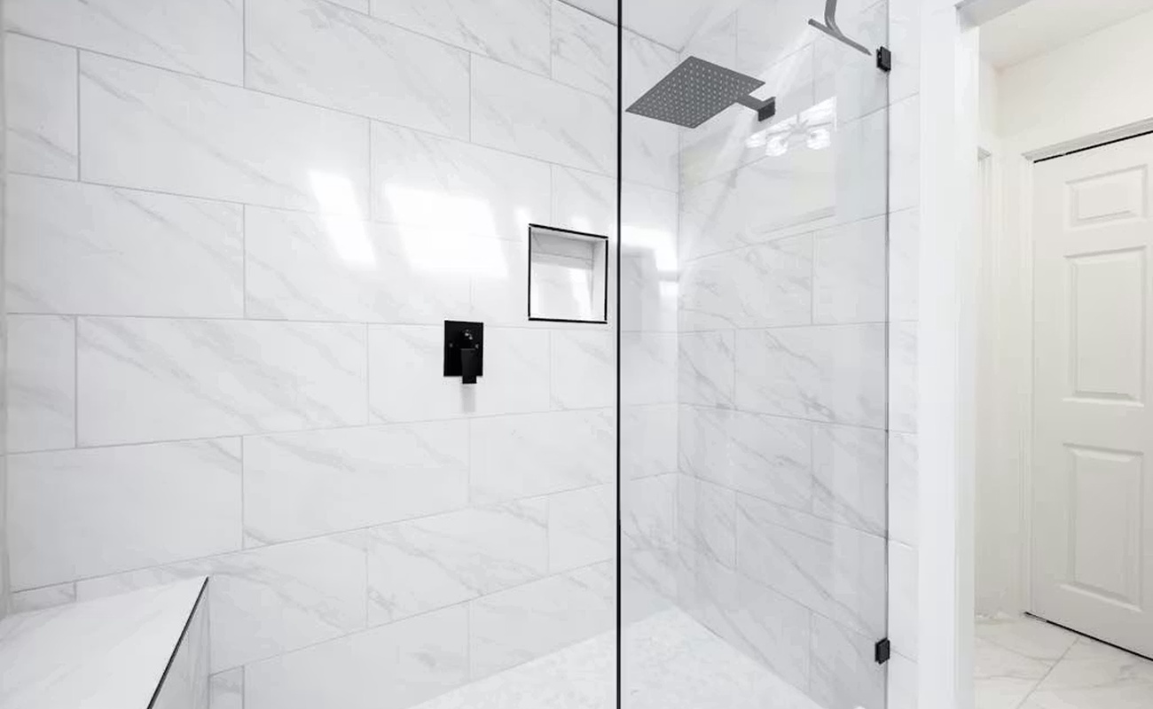 Step into your spa-like shower with luxurious marble tiles and a sleek rainfall showerhead for your ultimate relaxation.