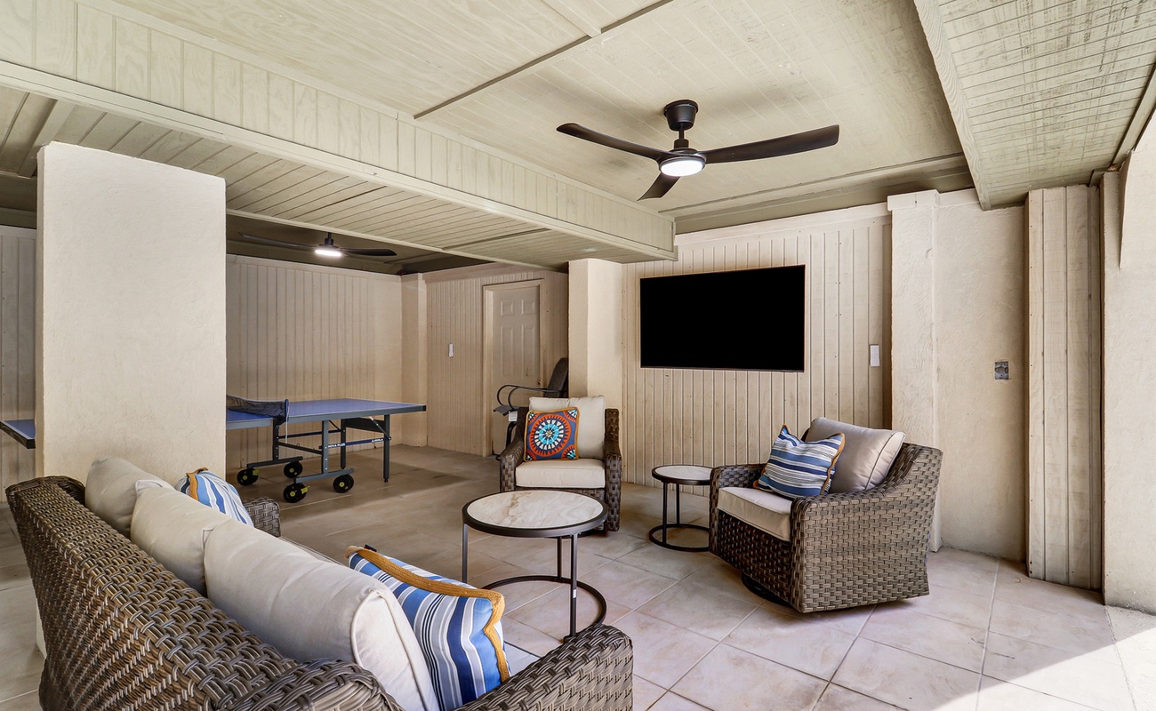 Your private game room features comfortable wicker seating and table tennis - perfect for evening entertainment after beach days.