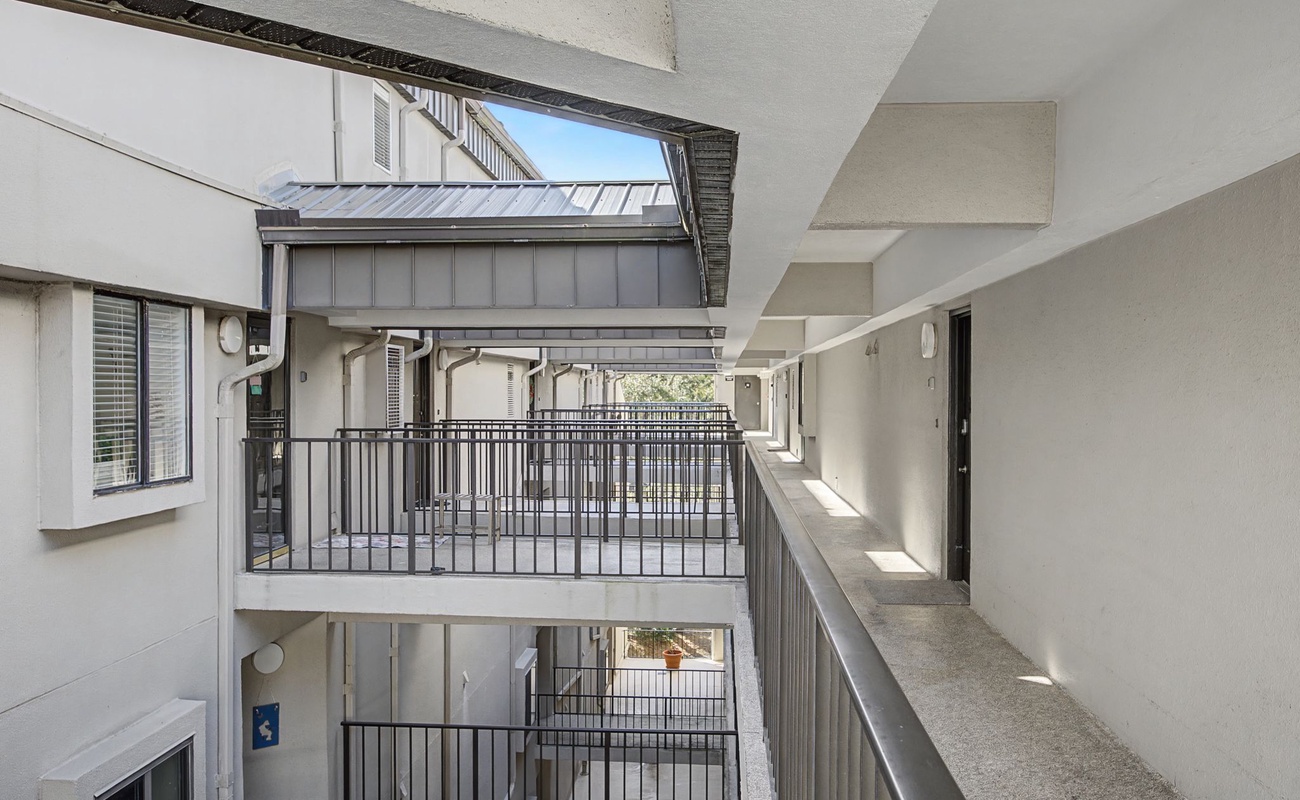 Multi-level property walkways connect your accommodations with modern railings and covered passages for comfort.