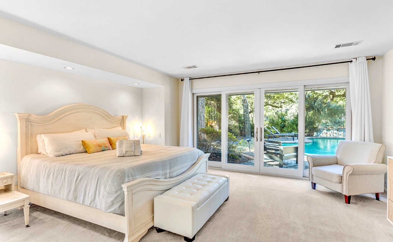 Wake up to pool views from your luxurious master bedroom, where crisp white linens and elegant furnishings create your private sanctuary.