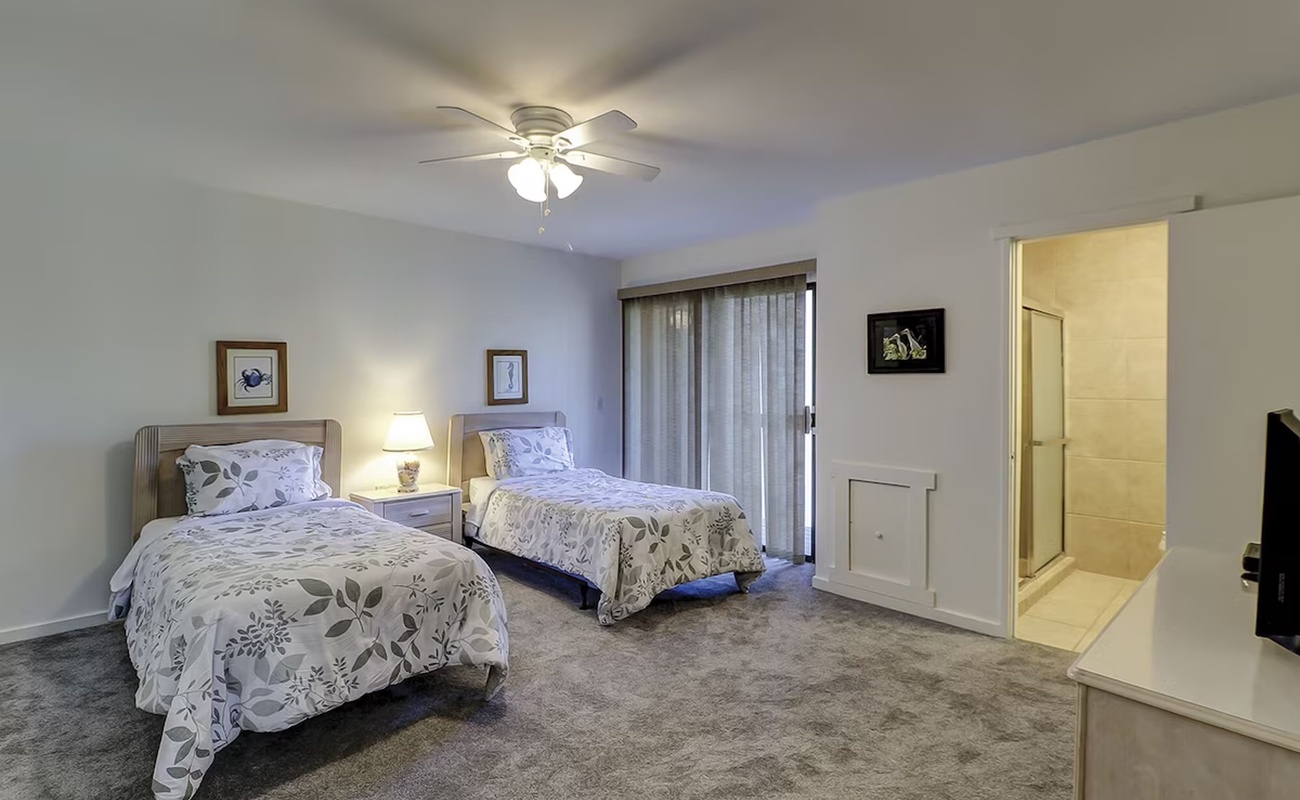 Rest peacefully in your twin bedroom with soft linens and gentle ceiling fan keeping you comfortable all night long.