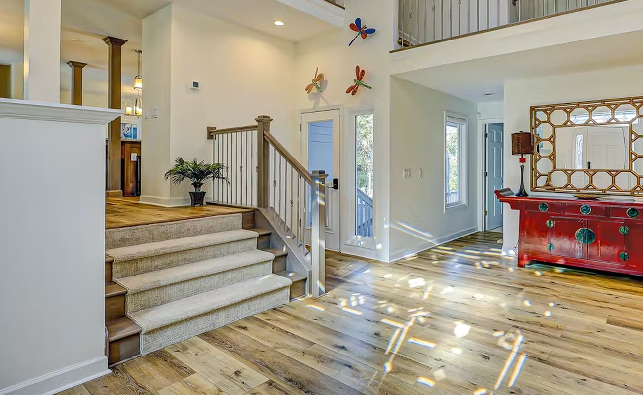 Step into your spacious foyer where natural light dances across beautiful hardwood floors, creating a warm welcome home feeling.