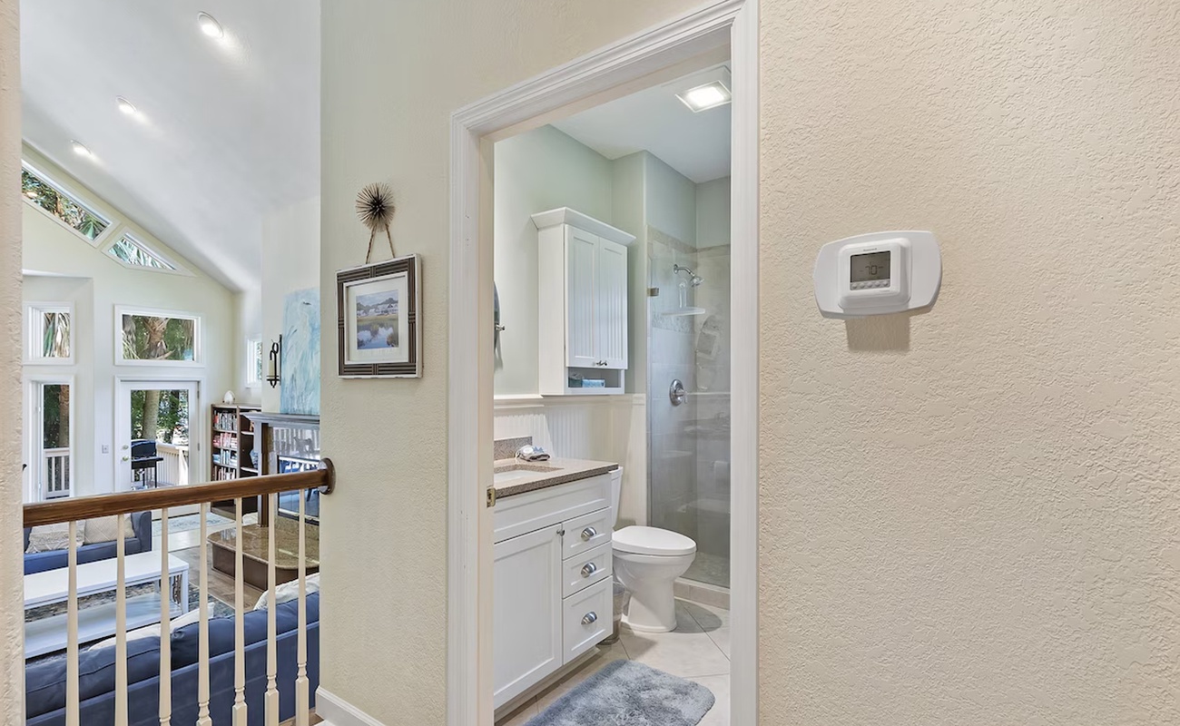 Your private bathroom features a modern shower, fresh white cabinetry, and plush soft towels for ultimate comfort.