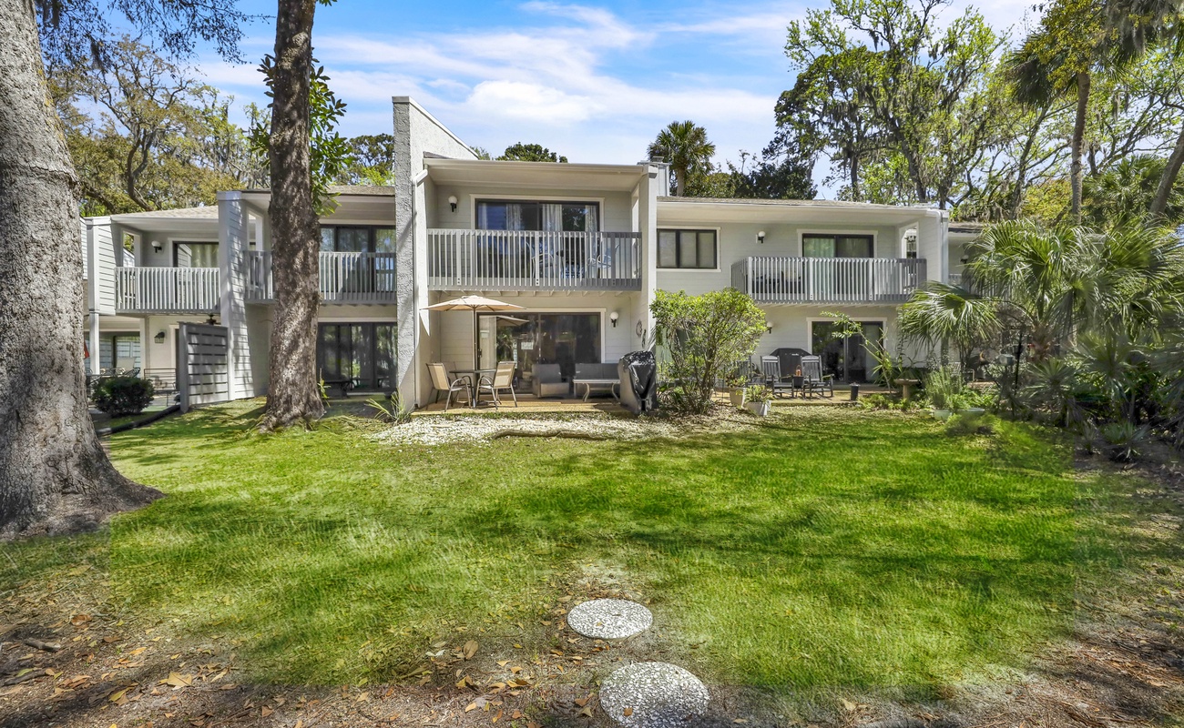 Back Exterior of Home with Private Patio and Lagoon Views