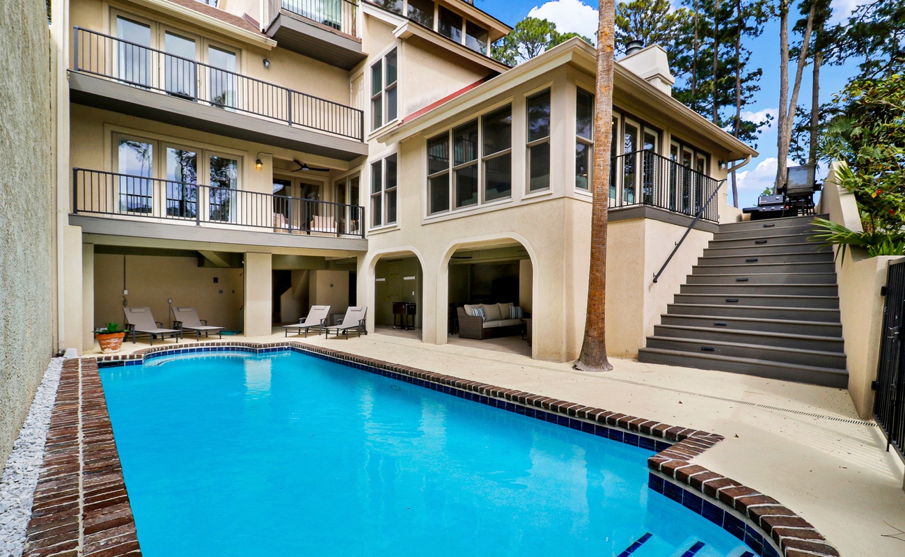 Private pool area at 26 Spinnaker Court with ample space for lounging and outdoor living, offering a resort-style setting just moments from Harbour Town in Sea Pines.
