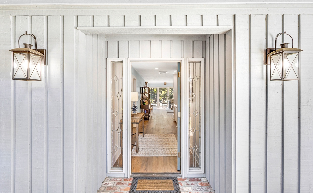 Step through this elegant entrance into your welcoming retreat, where charming lantern lighting and thoughtful details create the perfect first impression.