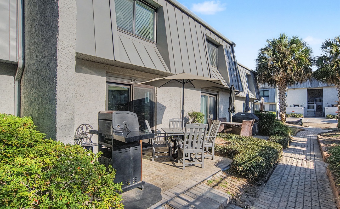 Step onto your private patio where coastal breezes meet BBQ evenings under swaying palms—your perfect outdoor retreat awaits.