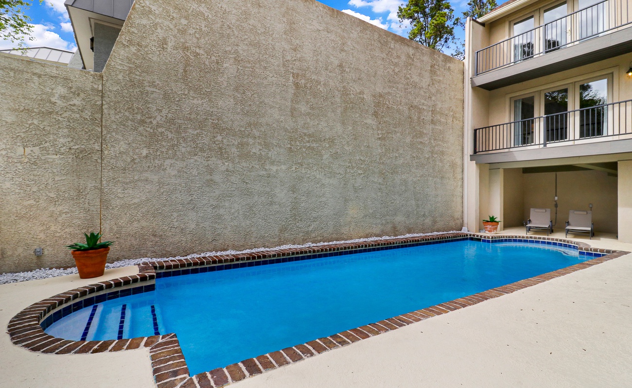 Dive into your own private oasis! This sparkling pool invites you to cool off while lounging chairs wait for your poolside relaxation.
