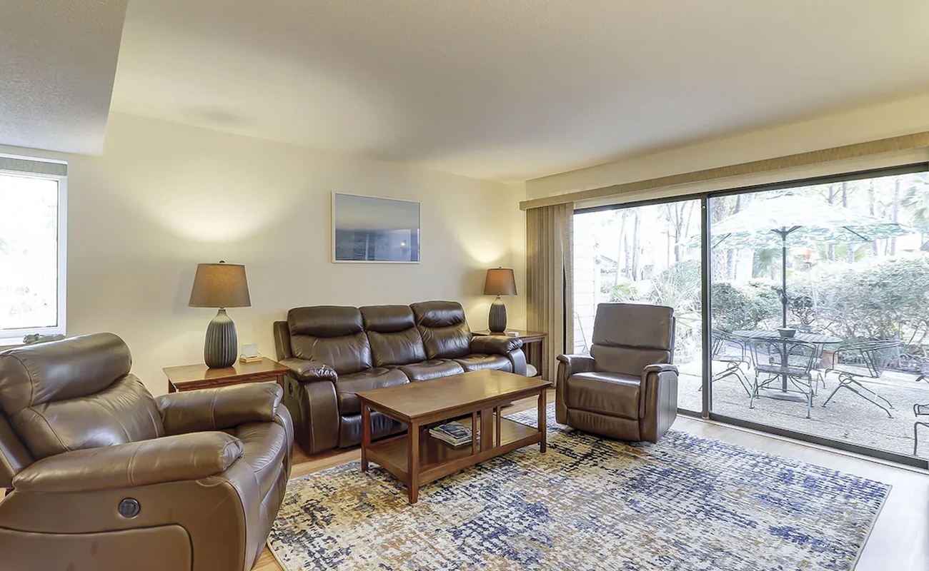 Sink into plush leather seating as natural light streams through your private patio doors, creating the perfect retreat.