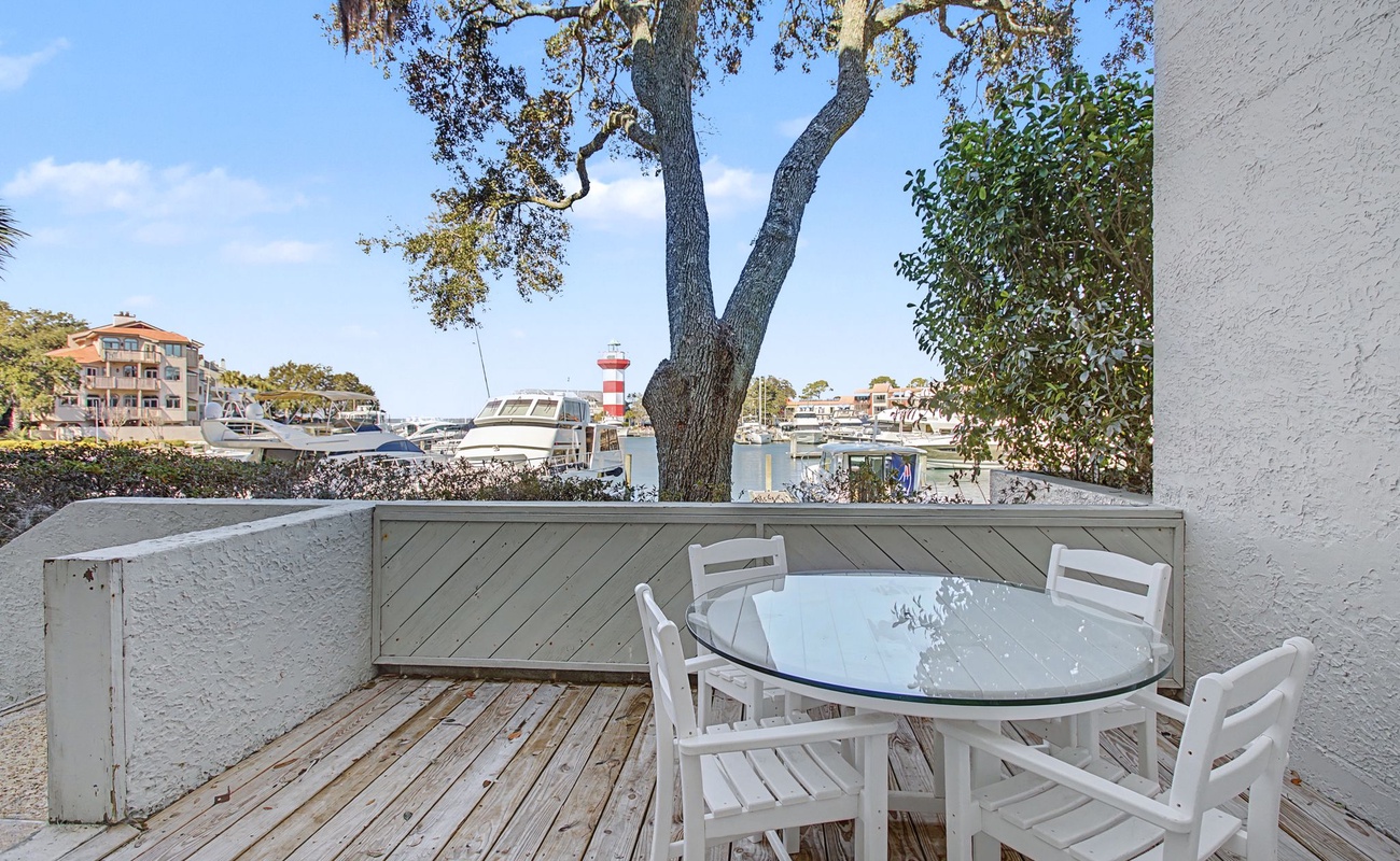 Enjoy morning coffee on your private deck overlooking the marina and famous lighthouse, with boats gently swaying and waterfront charm just steps away.