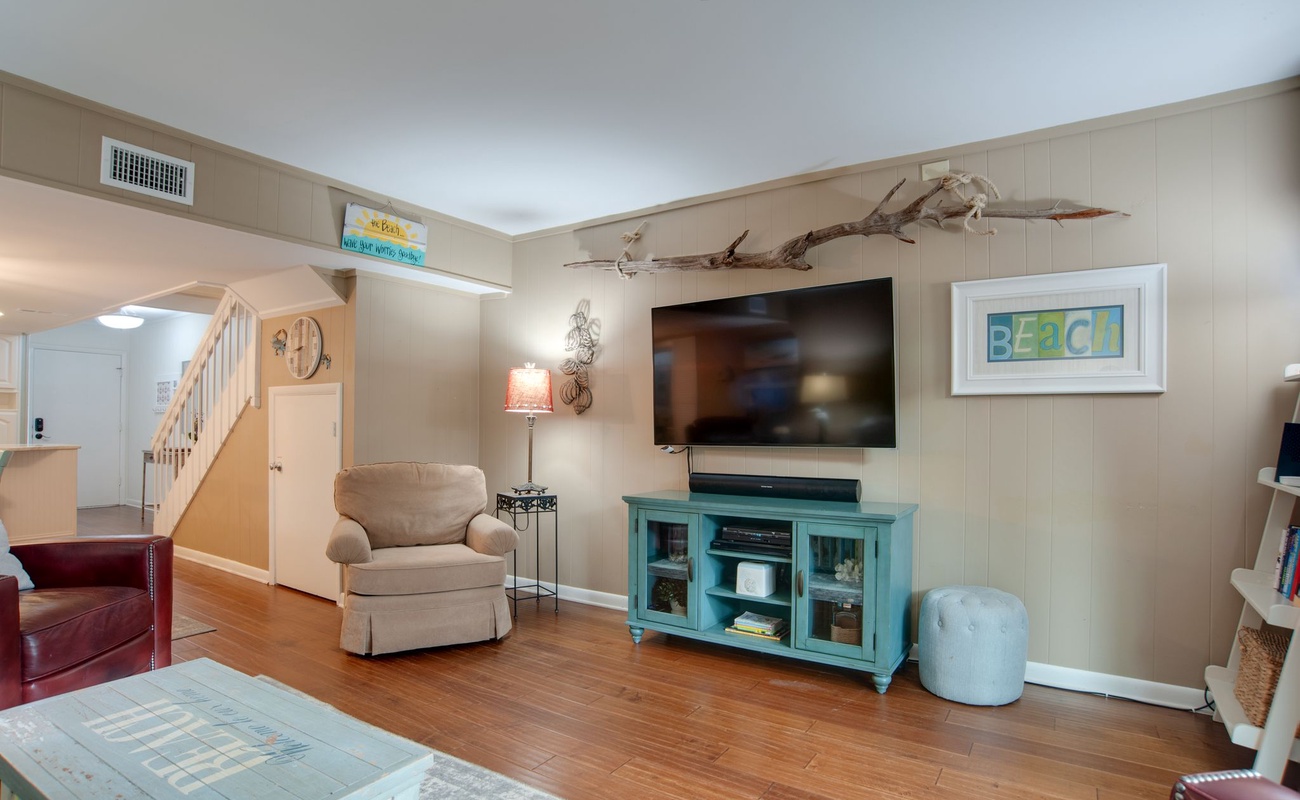 Settle into your cozy coastal living room, where beach-themed decor and comfortable seating create the perfect retreat after seaside adventures.