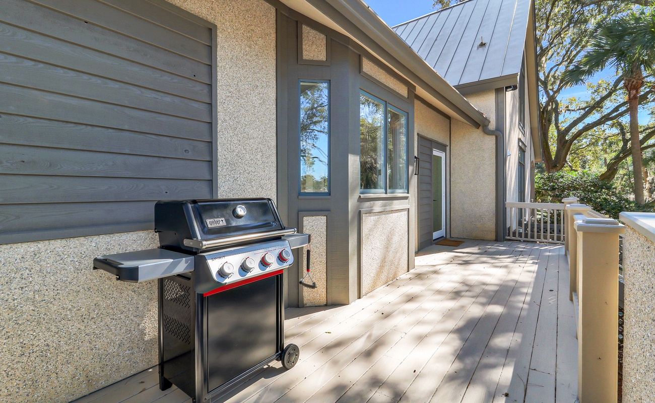 Step onto your private deck where a premium Weber grill awaits your outdoor cooking adventures under swaying palms.