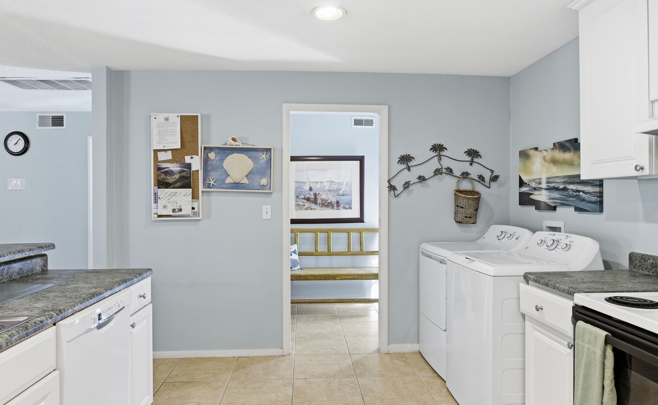 Your coastal retreat features a thoughtfully designed laundry space with modern appliances, making extended stays effortless and relaxing.