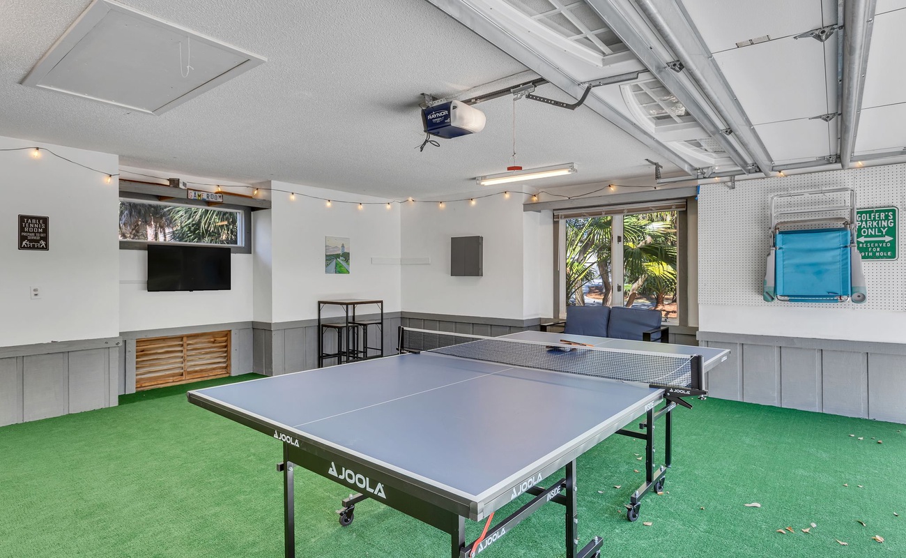 Challenge your friends to a game in your private recreational space, complete with professional ping pong table and entertainment setup.