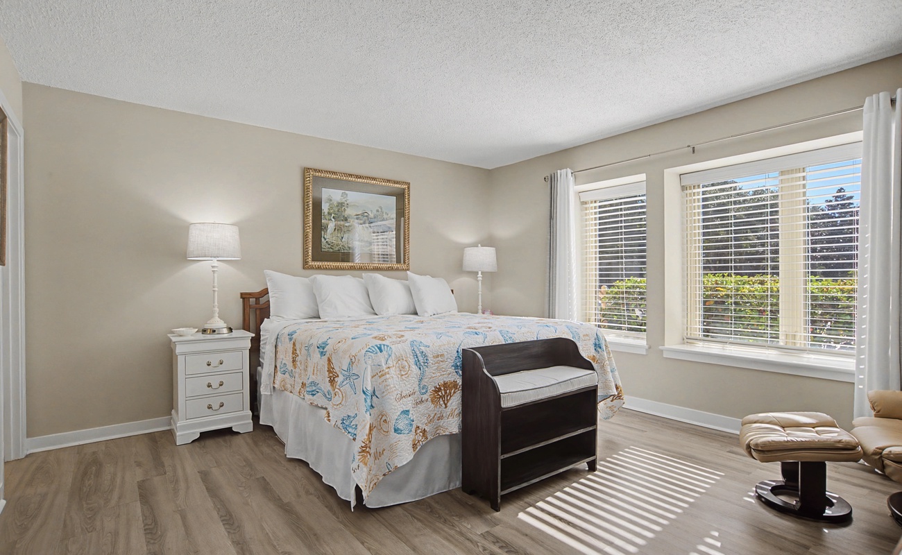 Drift off to sleep in this peaceful bedroom where soft linens and gentle sunlight create your perfect retreat.