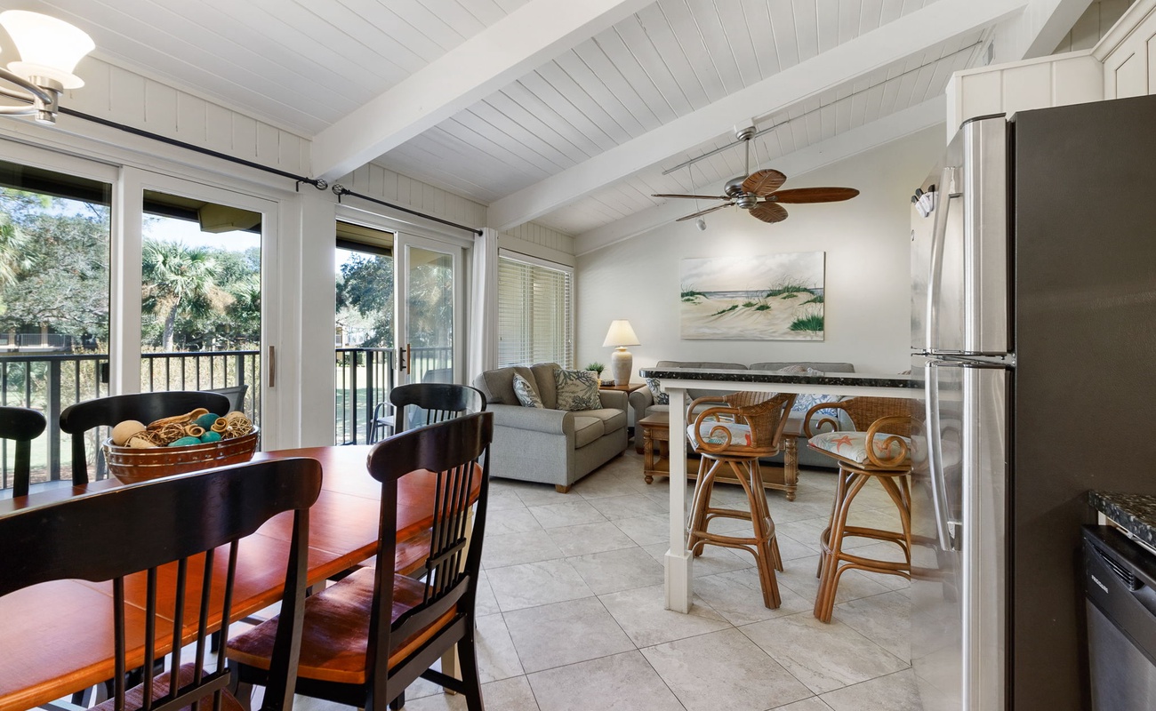 Unwind in your open-concept living space with coastal charm, exposed beams, and a kitchen perfect for vacation meals together.