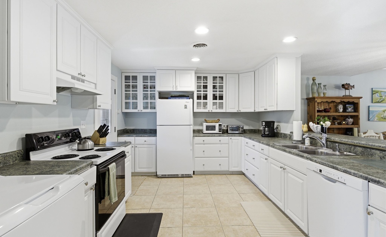 Your spacious kitchen features granite countertops, white cabinetry, and all the appliances you need for memorable meal preparation.