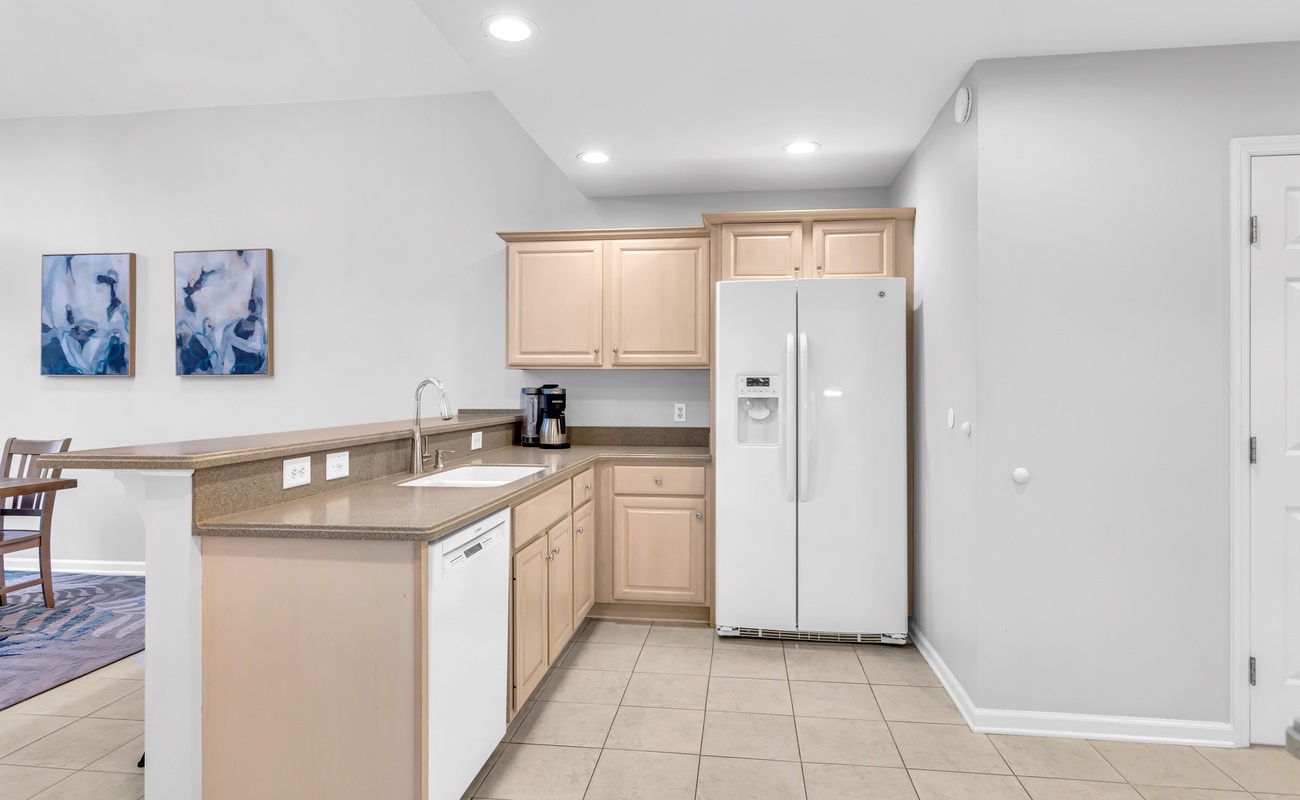 Your spacious kitchen features modern appliances, ample counter space, and sleek cabinetry—perfect for preparing meals during your stay.