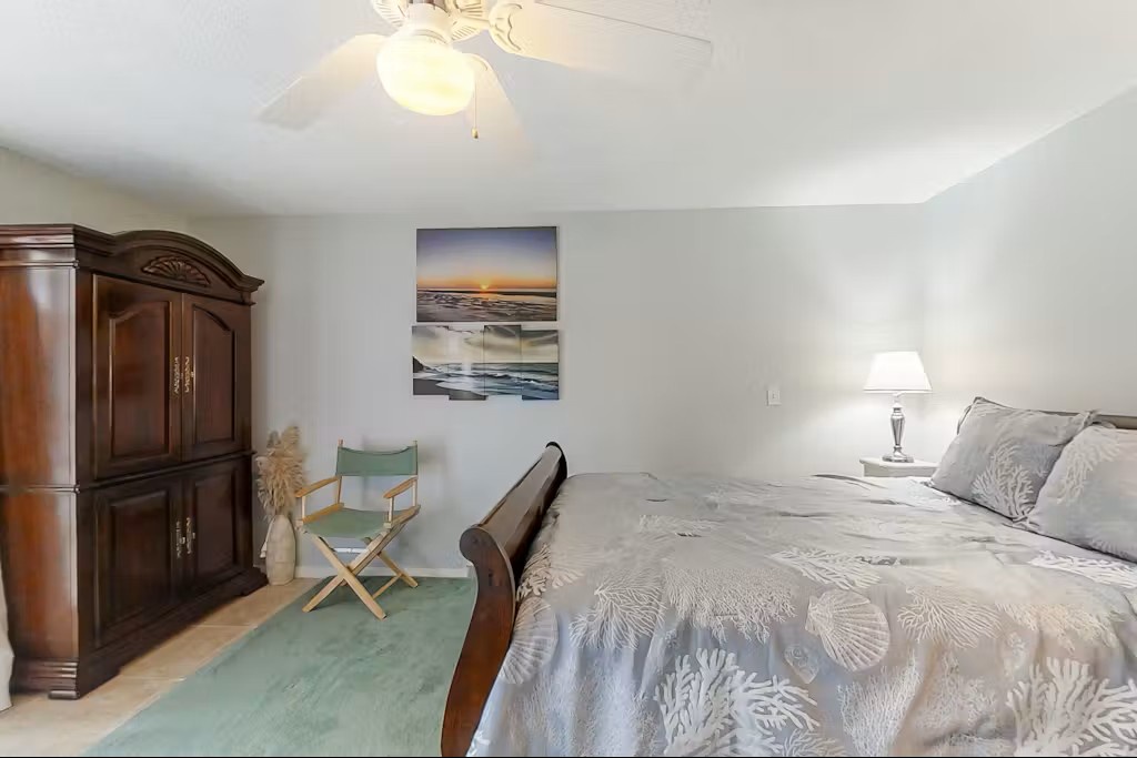 Drift off peacefully in your serene bedroom sanctuary, complete with coastal artwork and plush linens for ultimate comfort.