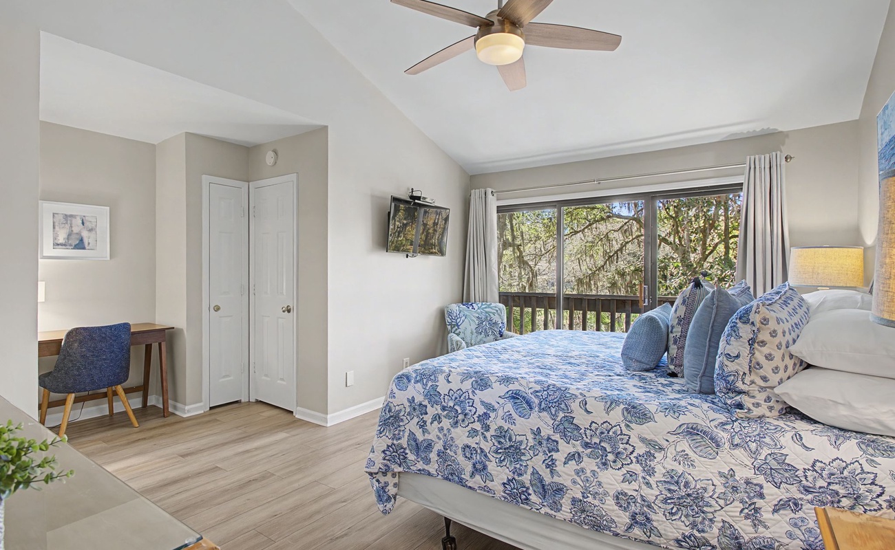 Drift off in your peaceful bedroom with charming blue florals, desk workspace, and leafy views through your private window.