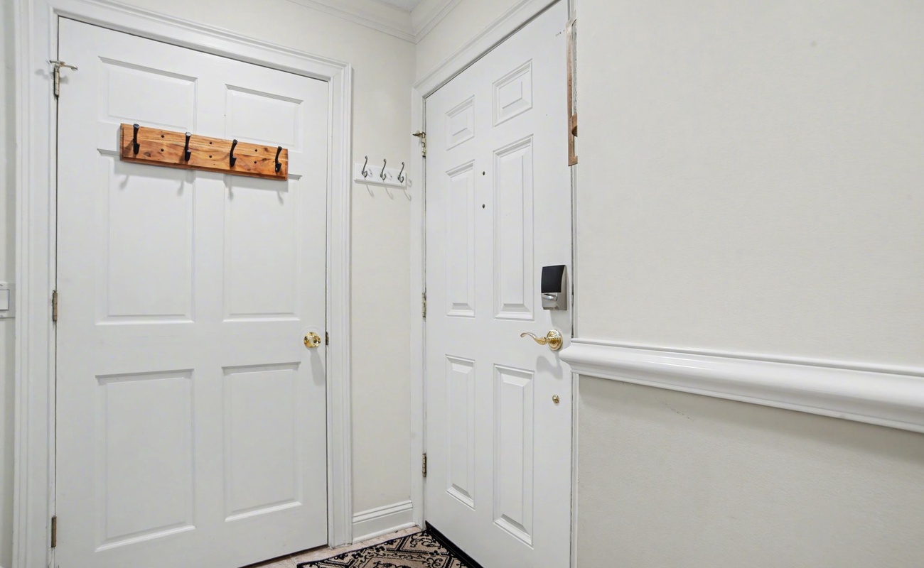 Step into your private entryway with convenient coat hooks and storage for all your belongings.