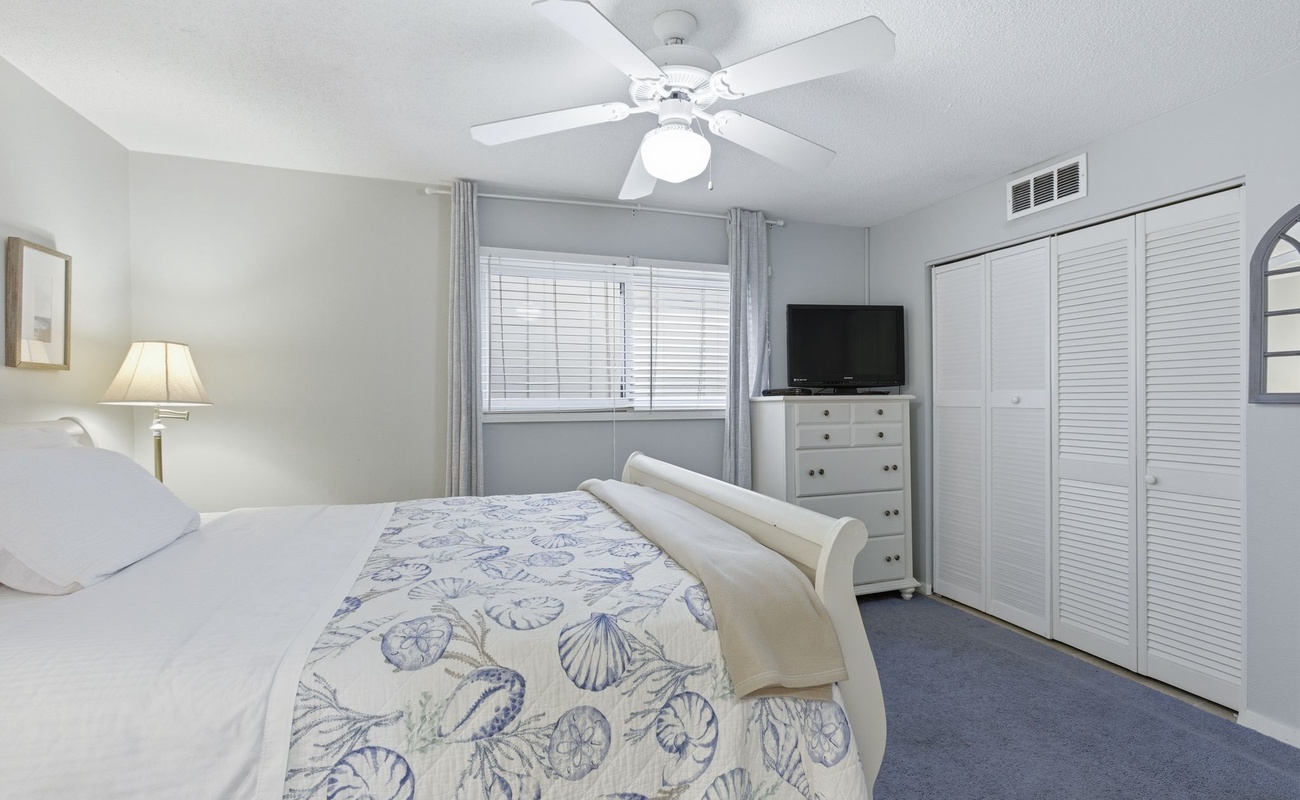 Drift off in your serene bedroom with coastal-themed linens, ceiling fan comfort, and ample closet space for all your getaway essentials.