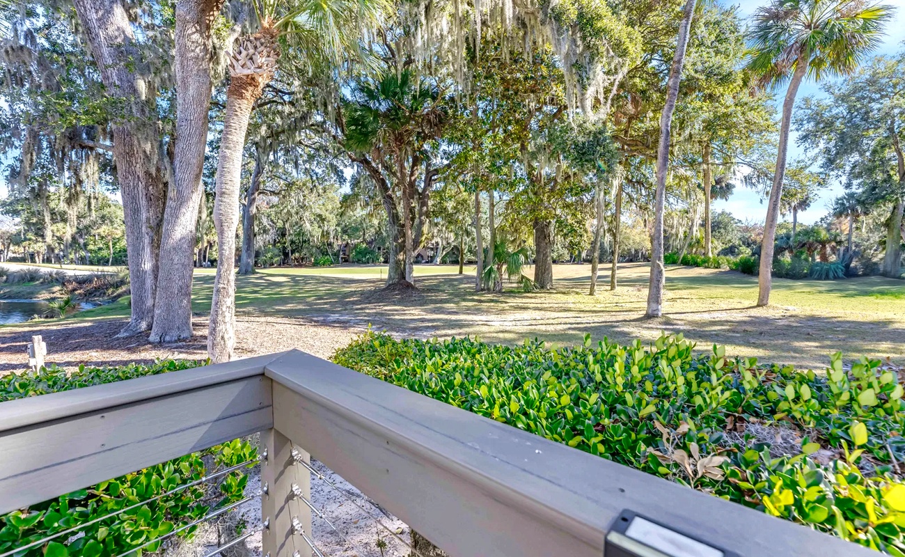 Peaceful golf course views with mature oak trees draped in Spanish moss create a serene backdrop for this Florida property.