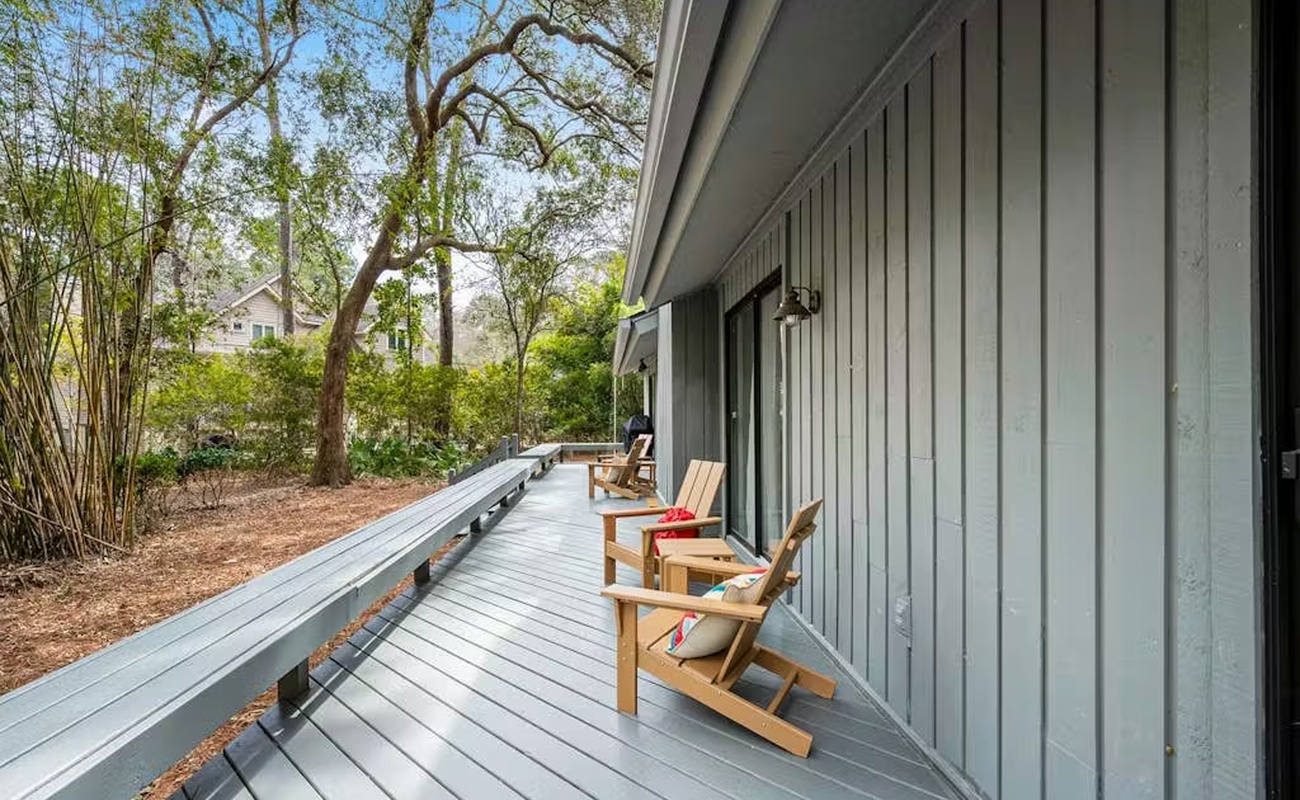 Step onto your private deck and sink into teak Adirondack chairs, where morning coffee tastes better surrounded by towering trees and peaceful garden views.