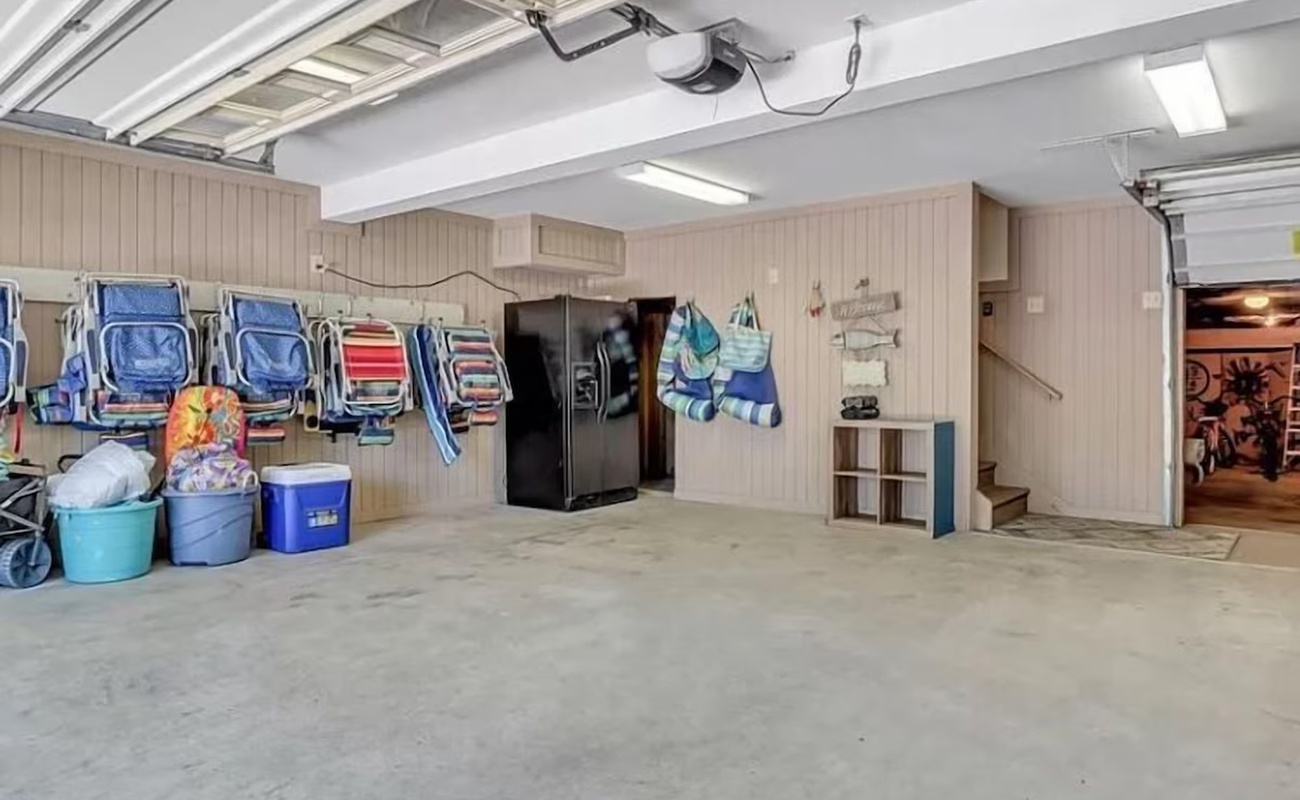 Your spacious garage offers plenty of room for beach gear storage, with chairs and coolers ready for your seaside adventures.