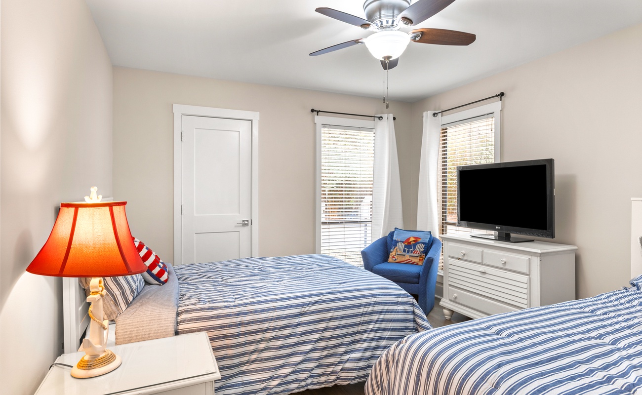 Drift off in this cozy bedroom with comfortable double beds, ceiling fan, and cheerful nautical touches that make you feel right at home.