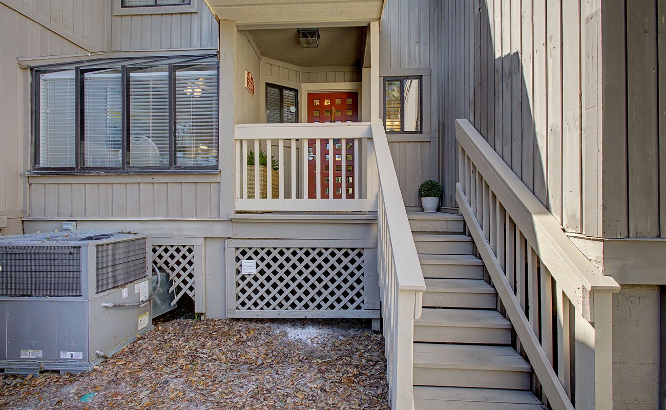 Charming property entrance with welcoming steps leading to your home away from home.