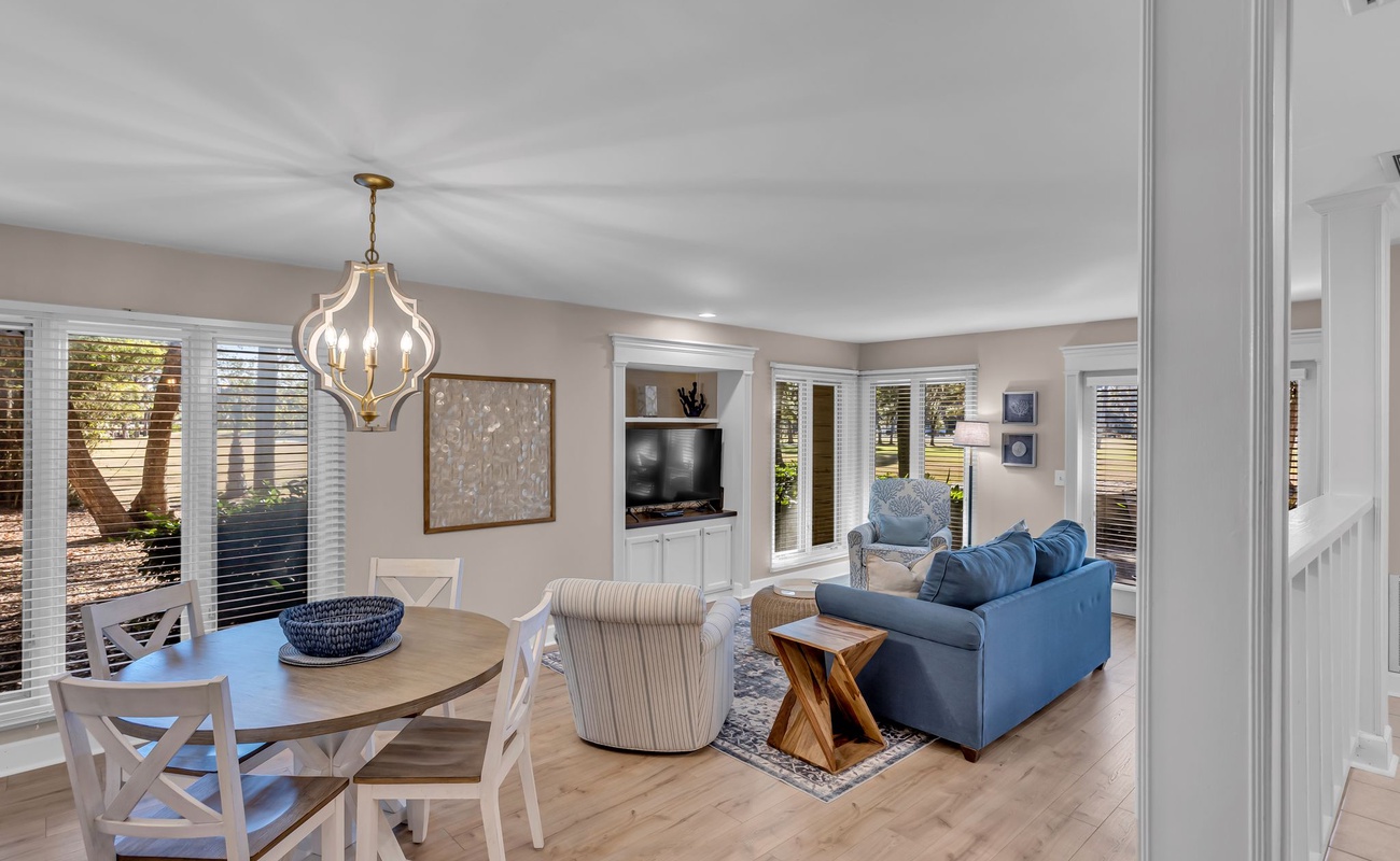 Unwind in your bright, open-concept living space where coastal blues meet modern comfort, perfect for relaxing after sunny adventures.