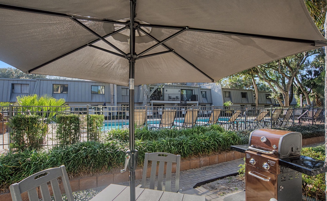 Fire up the grill under your private umbrella while enjoying pool views and tropical landscaping in your dedicated BBQ area.